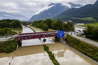 The Rhone River is overflowing the A9 motorway following the storms that caused major flooding, in Sierre, Switzerland, Sunday, June 30, 2024. (KEYSTONE/Jean-Christophe Bott)